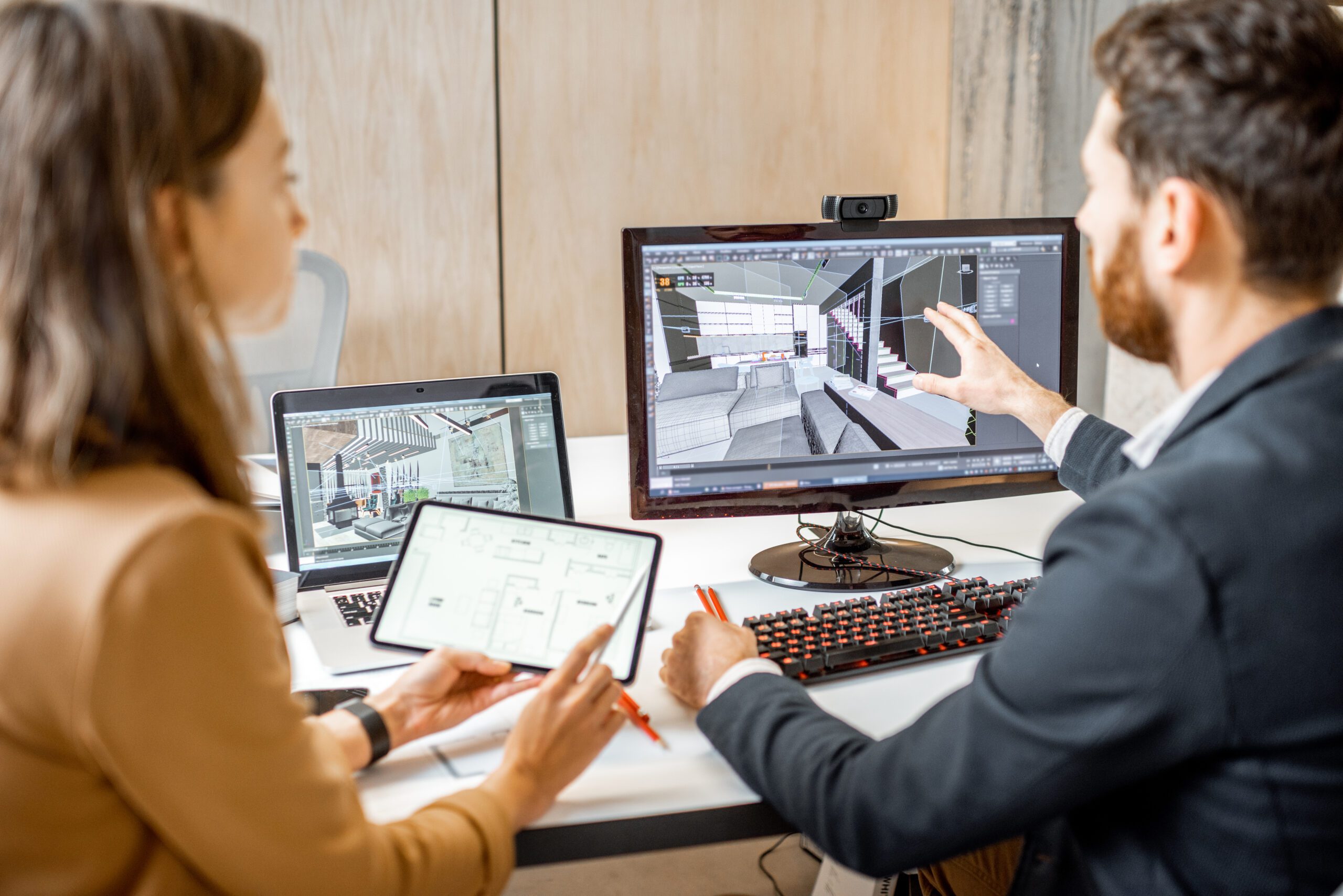 a man and woman are looking at a computer screen.