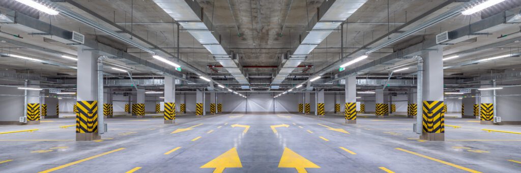 a parking garage with yellow arrows.