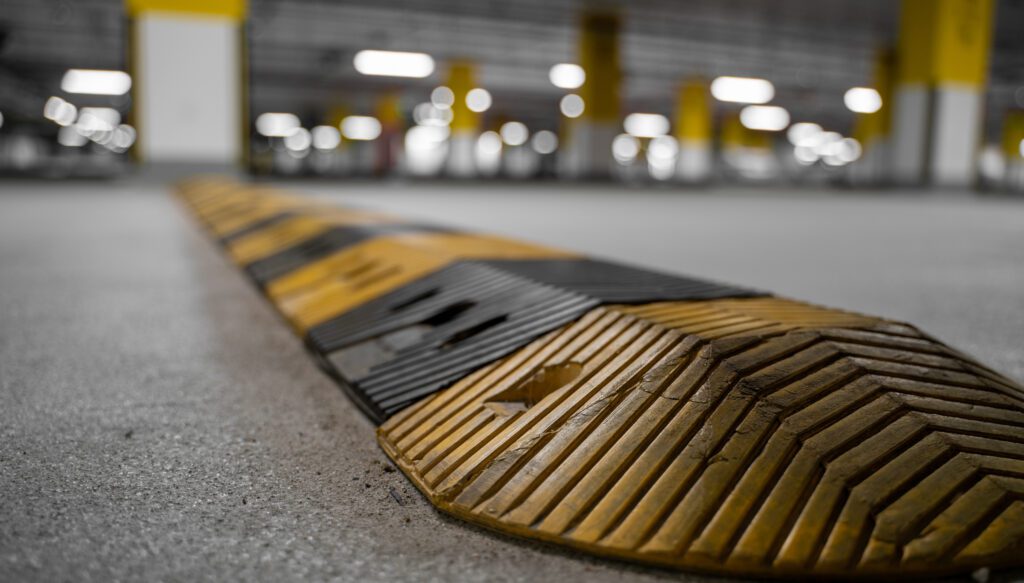 a yellow and black curb in a parking lot.