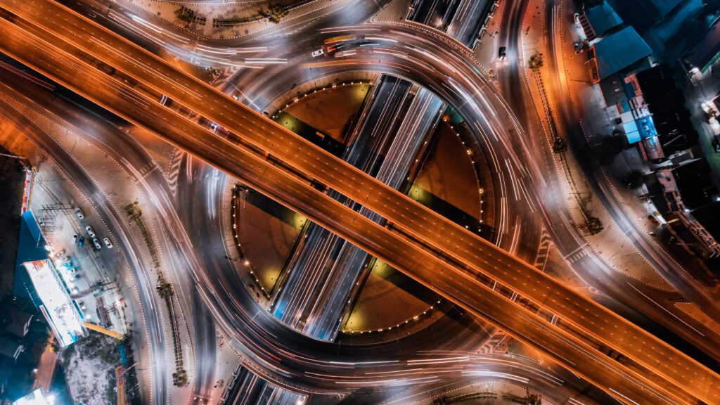 an aerial view of a city intersection at night.