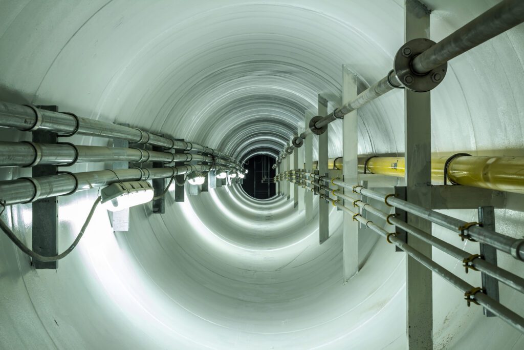 the inside of a tunnel with a light shining down on it.